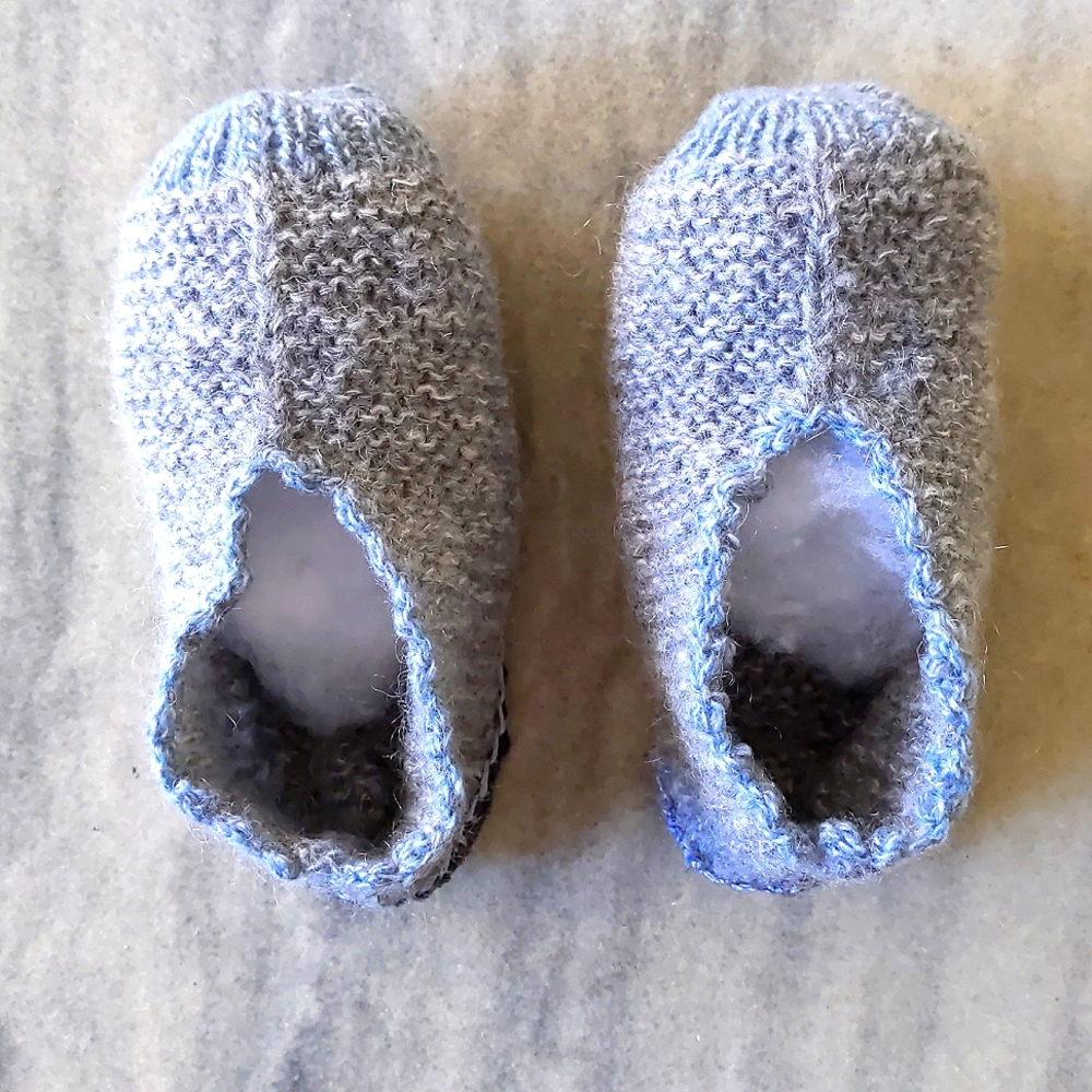 Brand new, handmade knitted kids foot warmer.